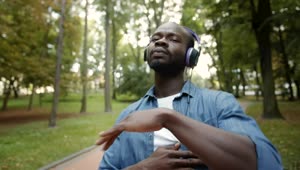 Download Stock Video Man In Headphones Dances Hiphop In Park Animated Wallpaper