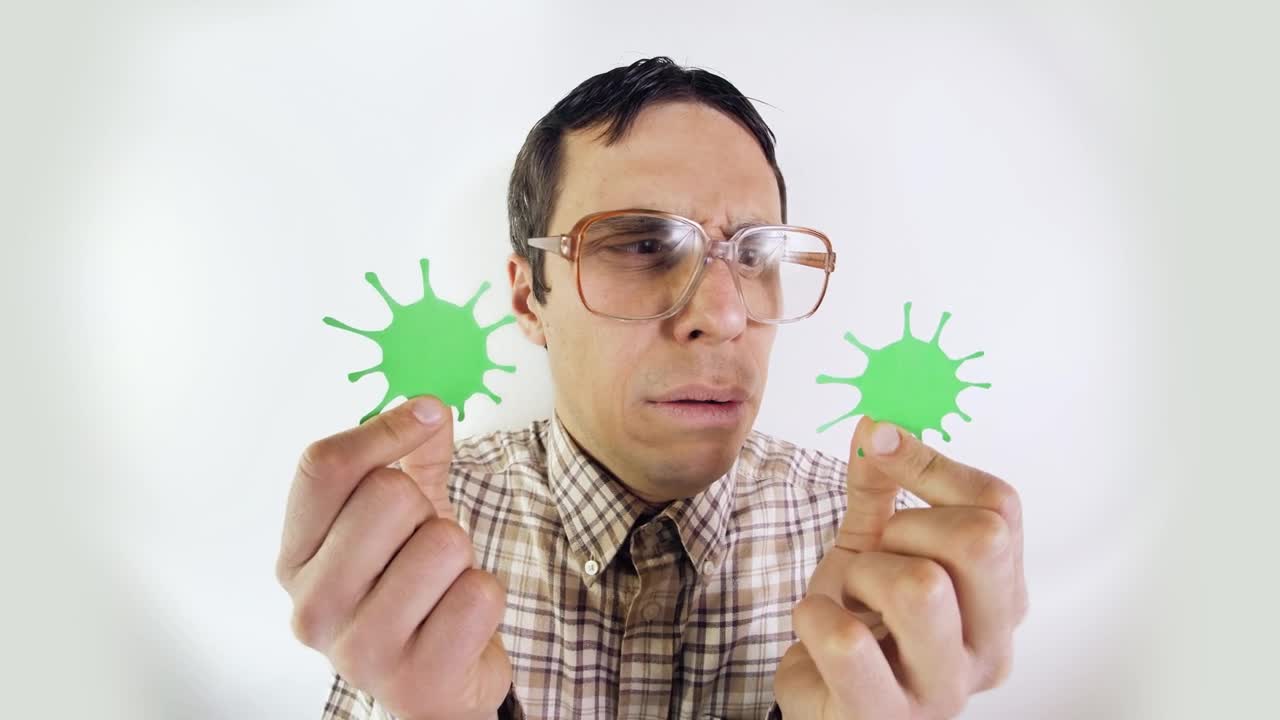 Download Stock Video Man In Glasses Looking At Forms Of Coronavirus Animated Wallpaper