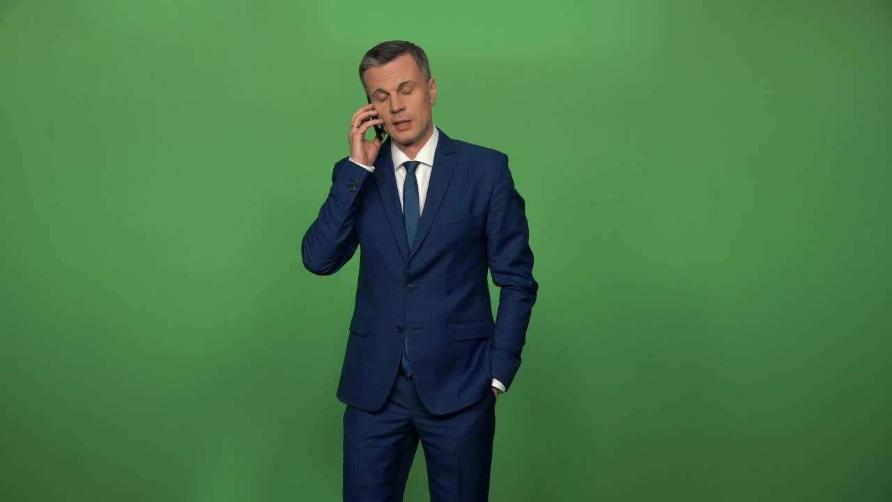 Download Stock Video Man In A Suit On A Phone Call In Front Animated Wallpaper