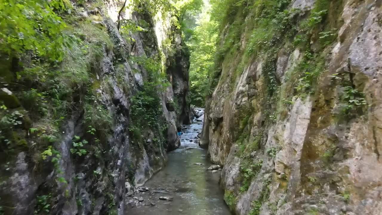 Download Stock Video Man Hiking In A Canyon With A Stream Animated Wallpaper