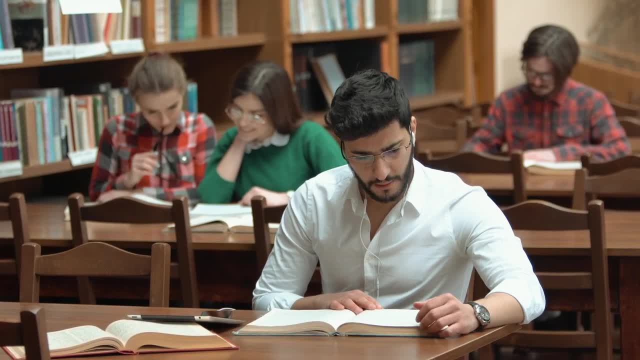 Download Stock Video Man Focused On Study For Exam In Library Animated Wallpaper