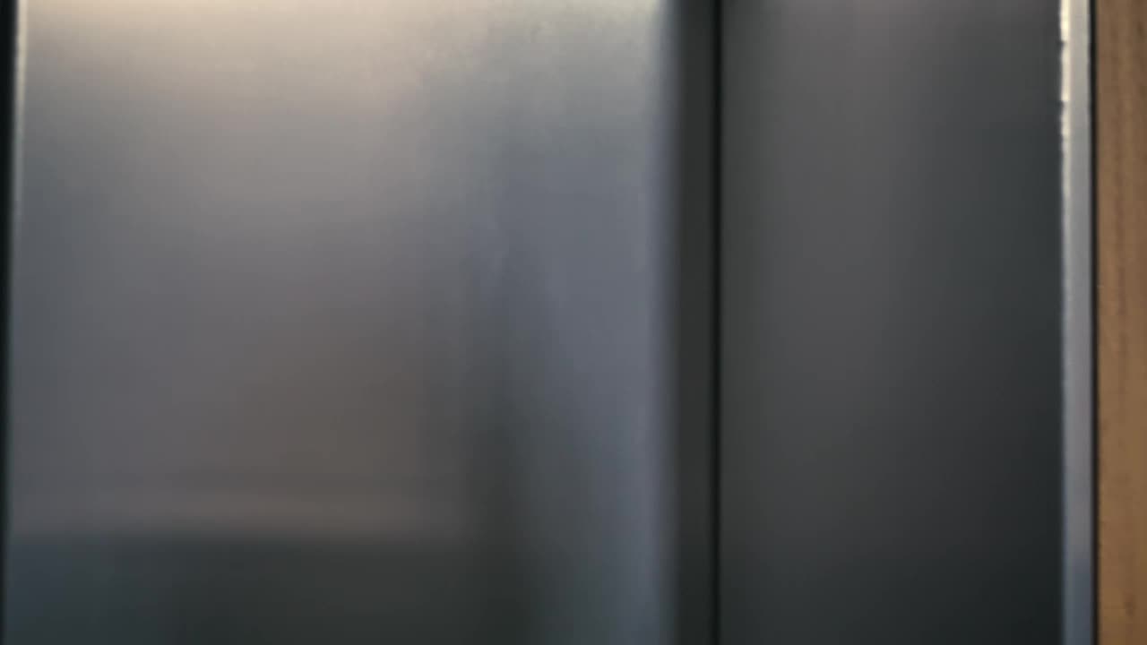 Download Stock Video Man Enters An Elevator Tapping His Wireless Earphones Animated Wallpaper