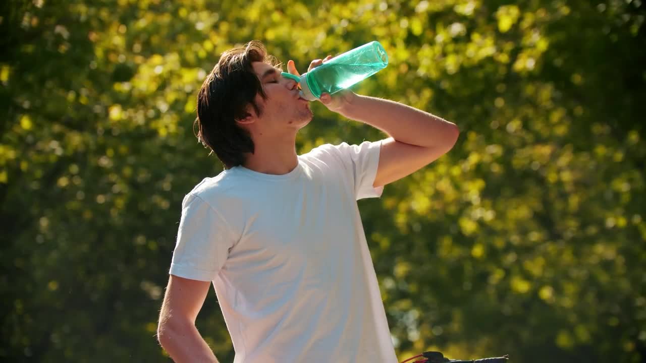 Download Stock Video Man Drinking Water From A Bottle And Riding His Bike Animated Wallpaper