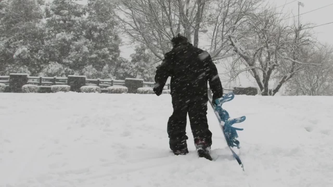 Download Stock Video Man Dragging His Snowboard Animated Wallpaper