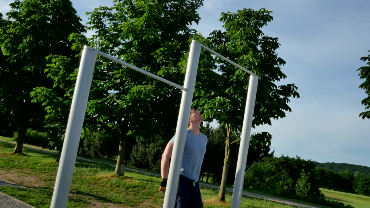 Download Stock Video Man Doing Pull Ups In The Park Animated Wallpaper