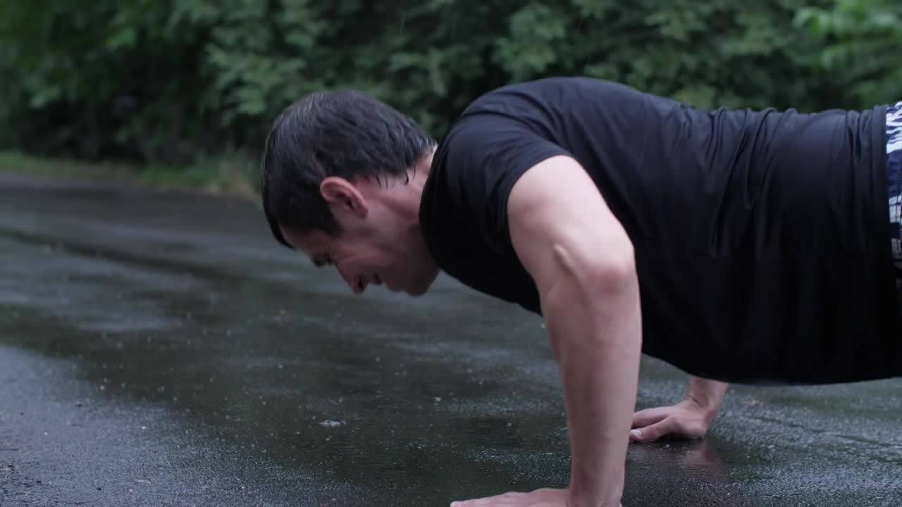 Download Stock Video Man Doing Hard Push Ups In The Rain Animated Wallpaper