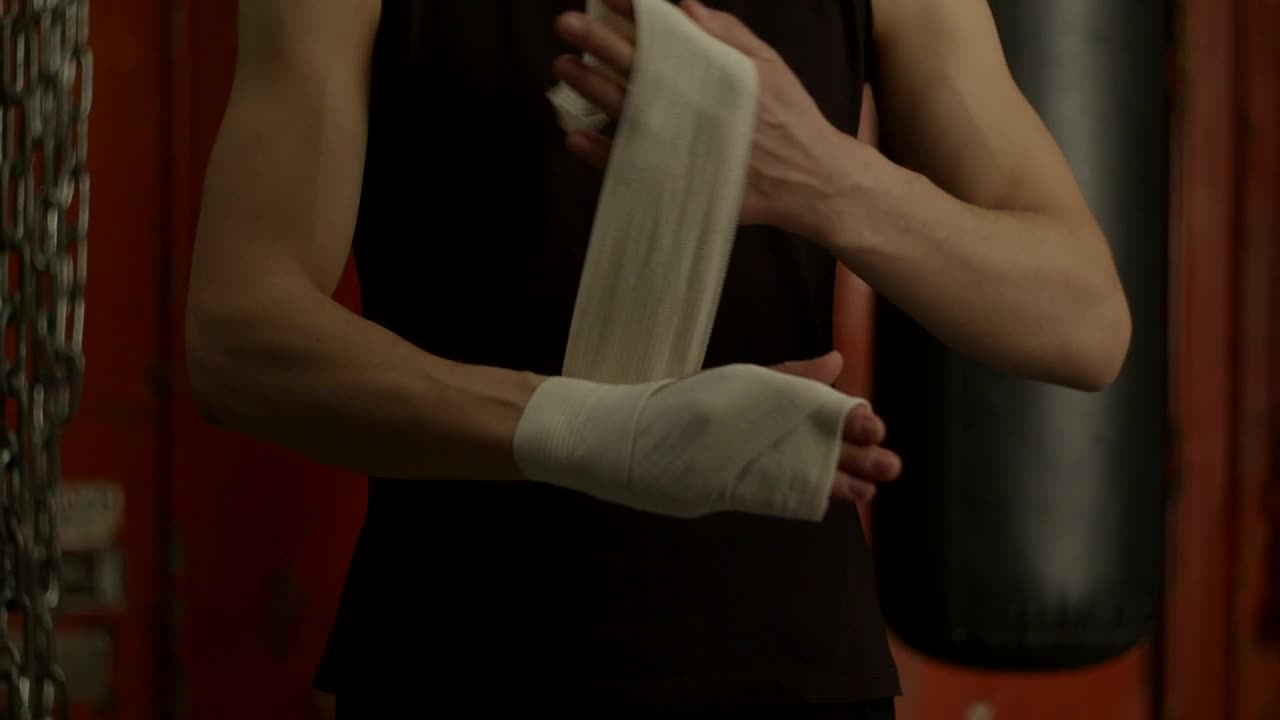 Download Stock Video Man Bandaging His Hand Before Boxing Animated Wallpaper