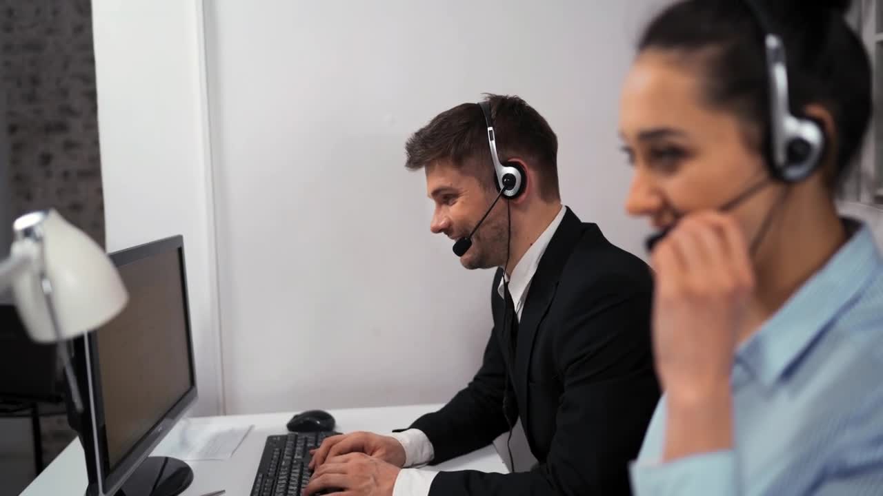 Download Stock Video Man And Woman Working In A Call Center Animated Wallpaper