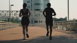 Download Stock Video Man And Woman Jogging Together On The Street Animated Wallpaper