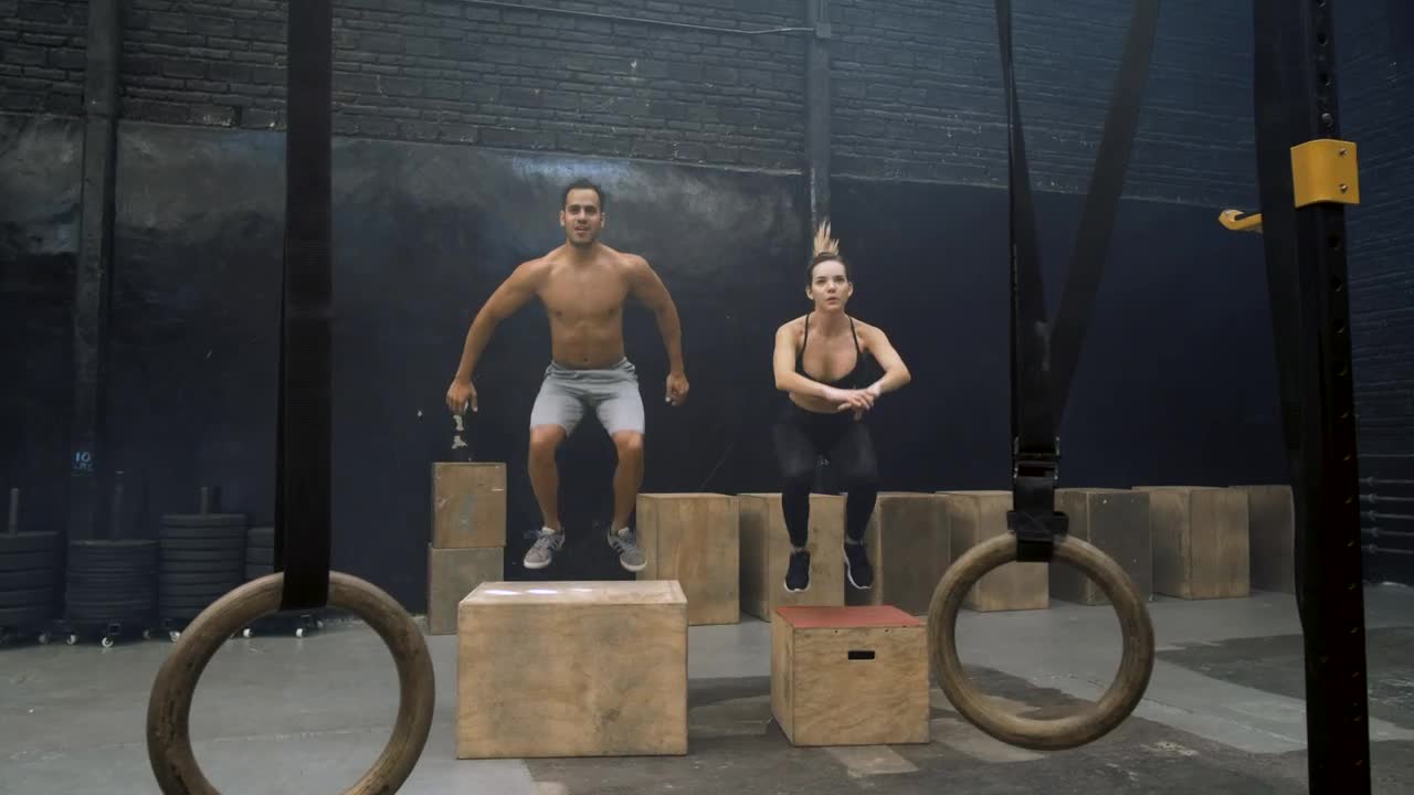 Download Stock Video Man And Woman Doing Box Jump Animated Wallpaper