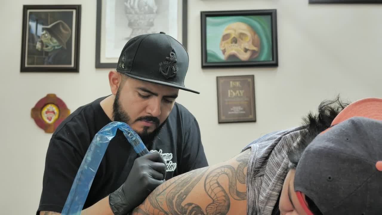 Download Stock Video Male Tattooist Working On A Tattoo Animated Wallpaper