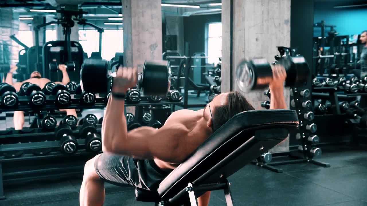 Download Stock Video Male Bodybuilder Doing Chest Exercises With Dumbbells Animated Wallpaper