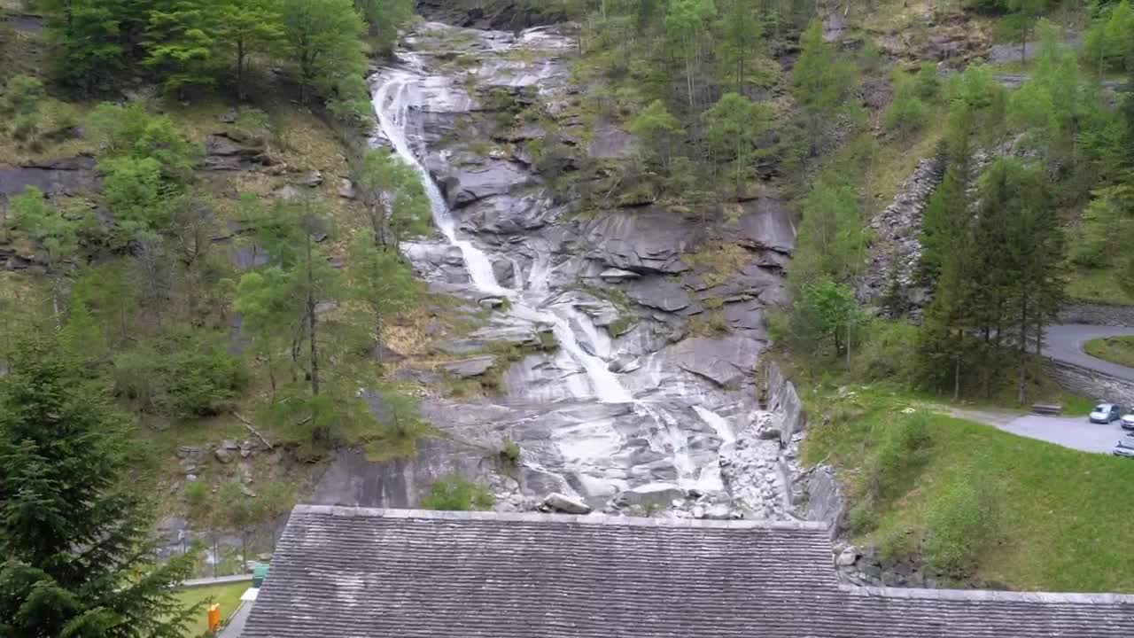 Download Stock Video Low View Of A Waterfall On A Forested Mountain Animated Wallpaper