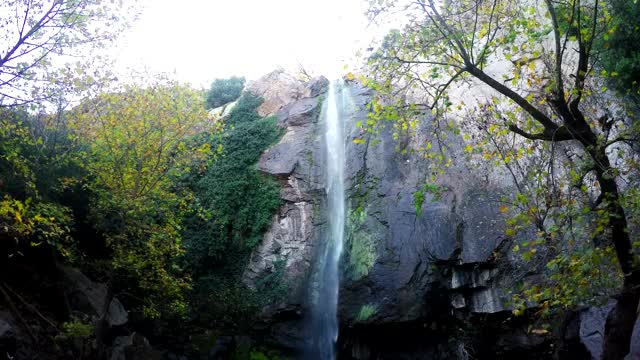 Download Stock Video Low View Of A Large Waterfall In A Rocky Forest Smal Animated Wallpaper