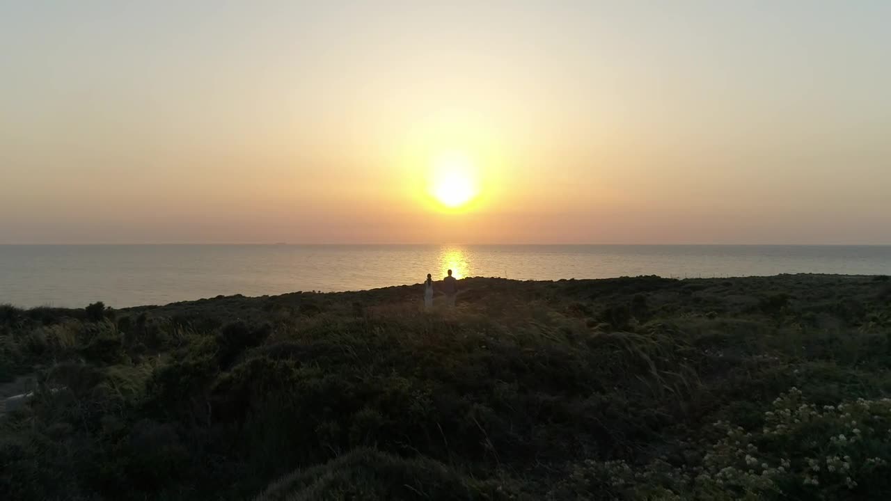 Download Stock Video Looking Towards The Sunset Over The Coast Animated Wallpaper