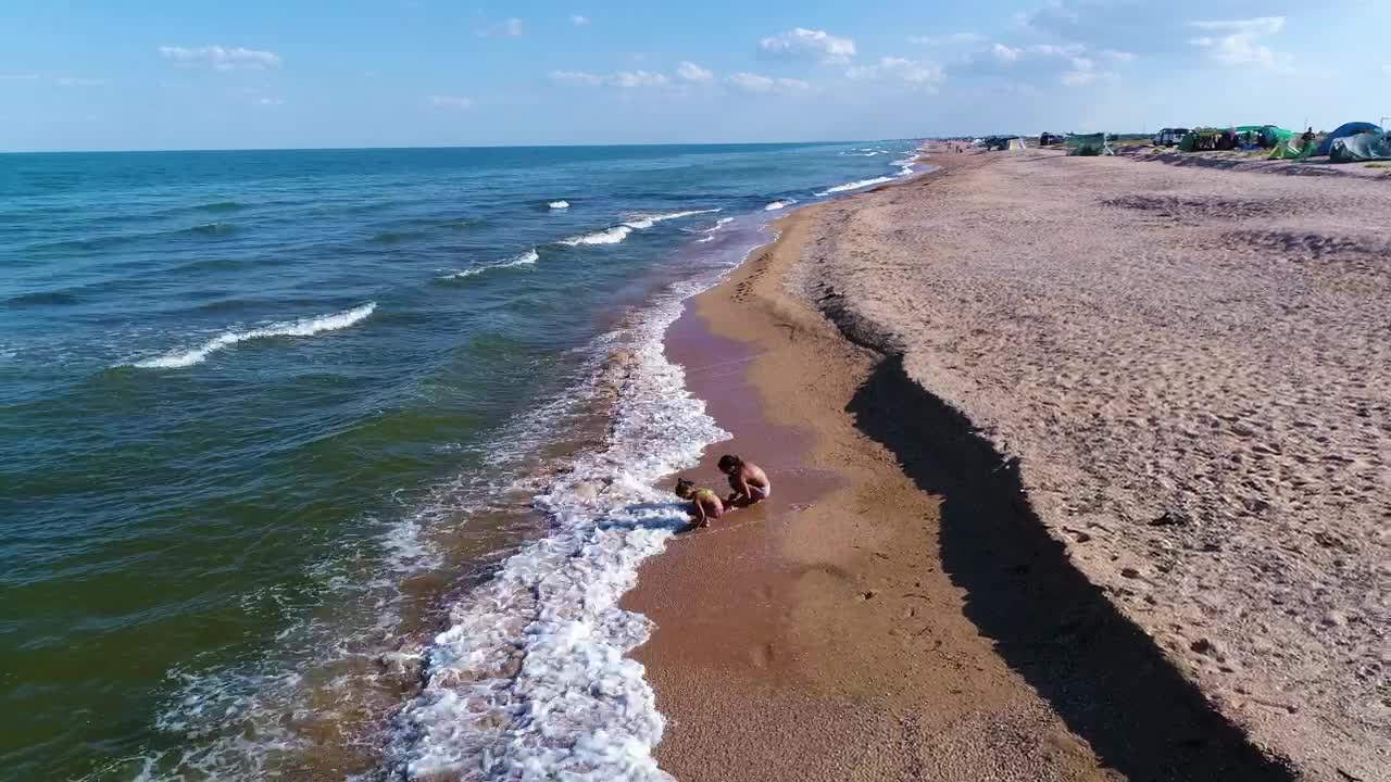 Download Stock Video Little Girls Play In The Sand With The Waves Of Animated Wallpaper