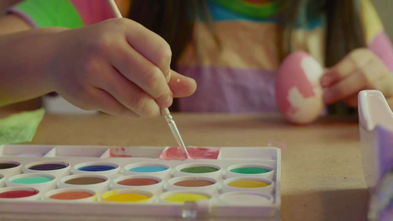 Download Stock Video Little Girl Painting An Egg With Pink Paint Animated Wallpaper