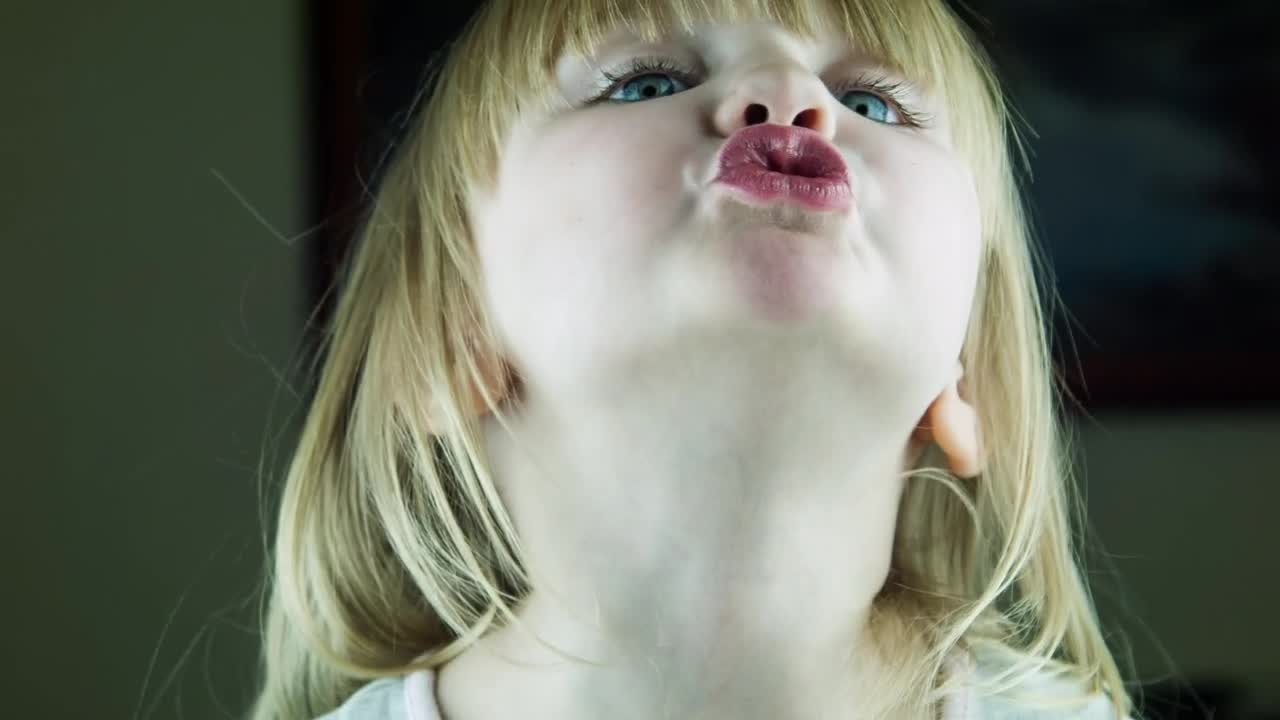 Download Stock Video Little Cute Girl Kissing To The Camera Animated Wallpaper