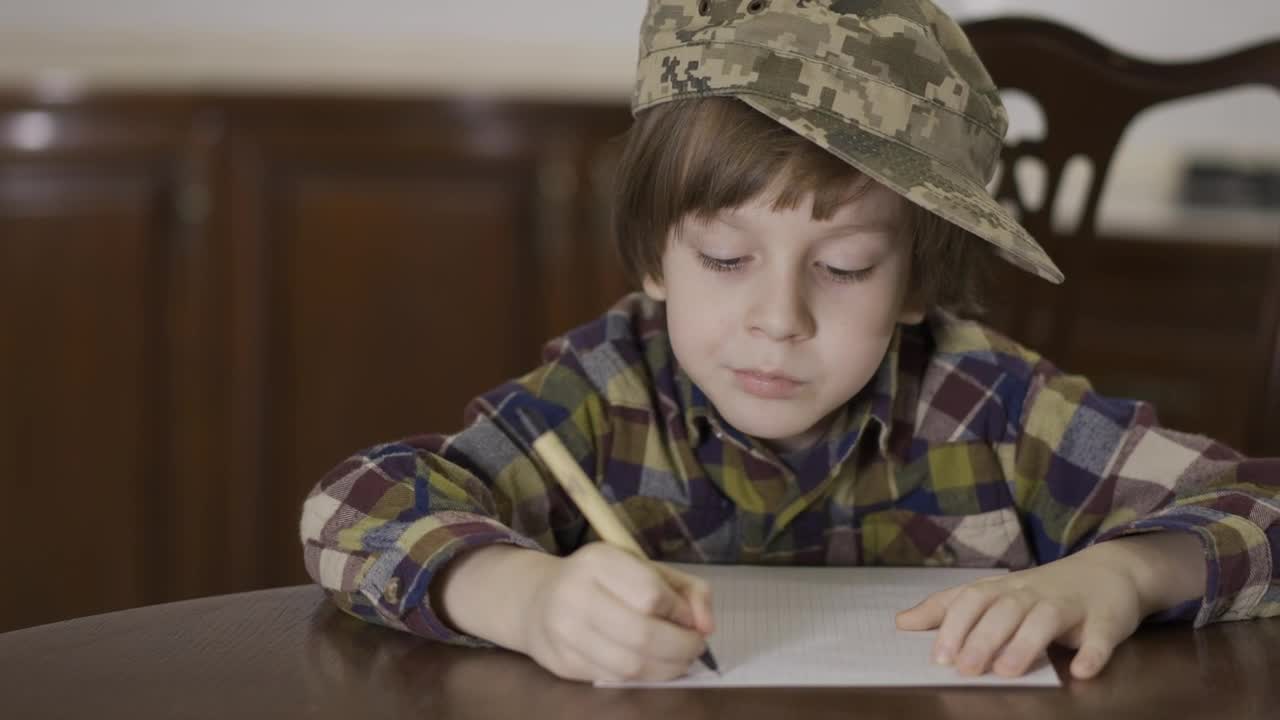 Download Stock Video Little Boy In Army Hat Writing Letter To Soldier Animated Wallpaper