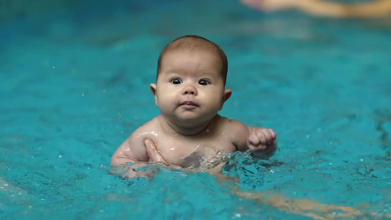 Download Stock Video Little Baby Learning To Swim In A Pool Animated Wallpaper