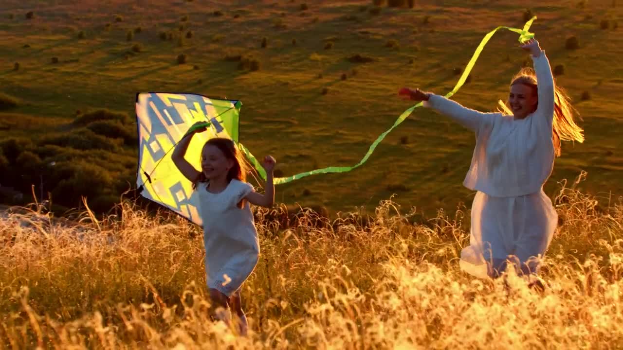 Download Stock Video Mother With Her Daughter Running On The Hill With Animated Wallpaper