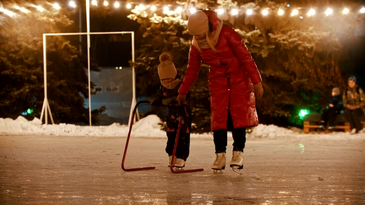 Download Stock Video Mother Teaching Her Daughter To Ice Skatin Animated Wallpaper