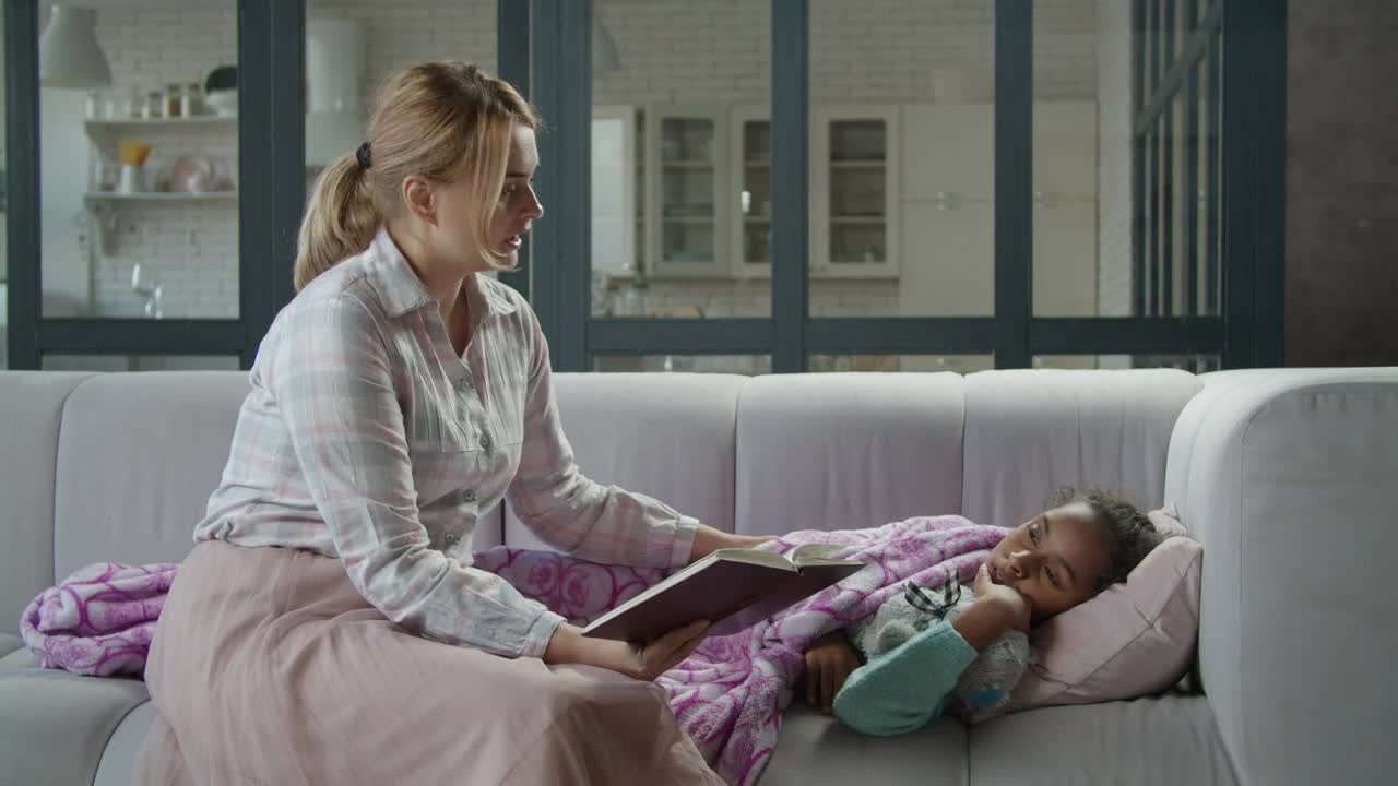 Download Stock Video Mother Reads A Book To Her Sick Daughte Animated Wallpaper