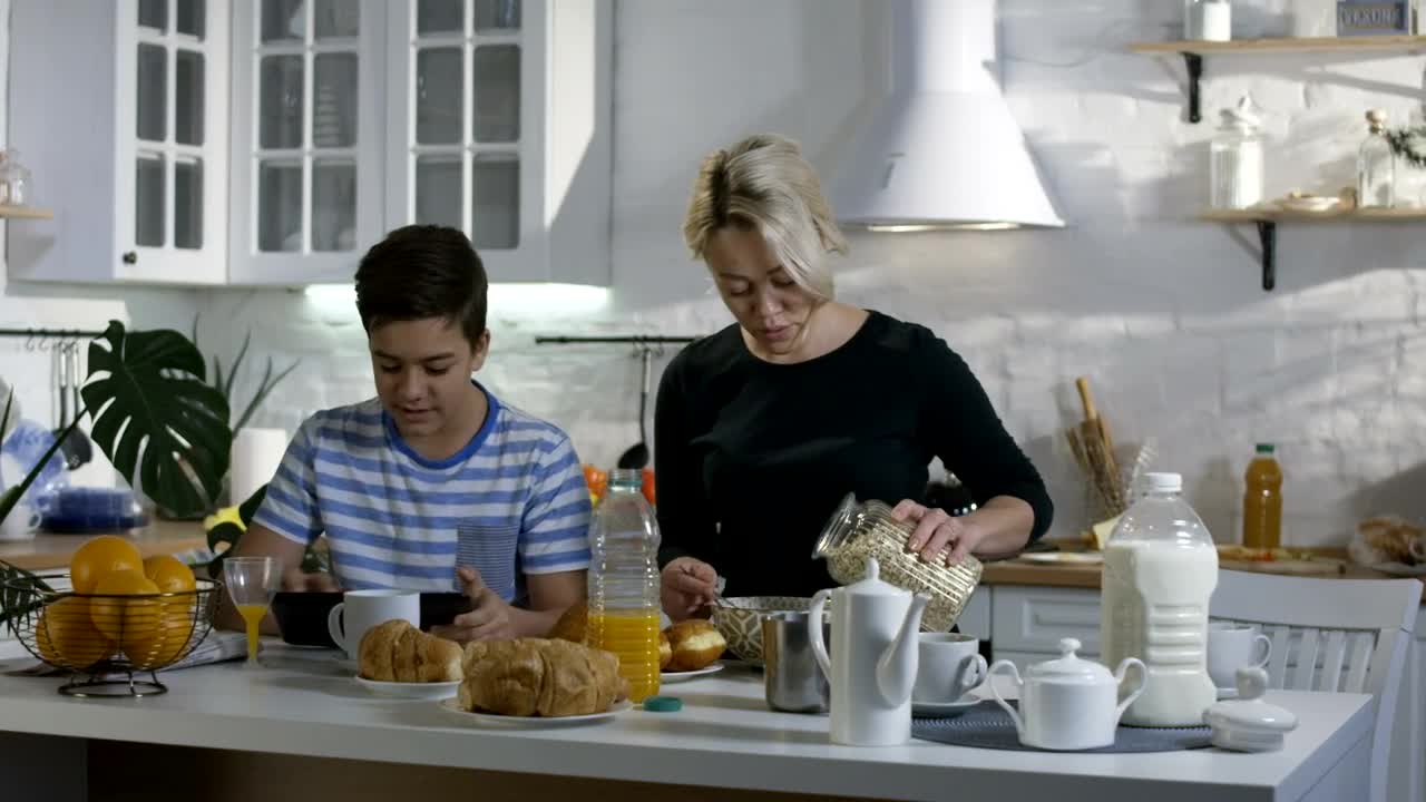 Download Stock Video Mother Preparing Breakfast For His So Animated Wallpaper