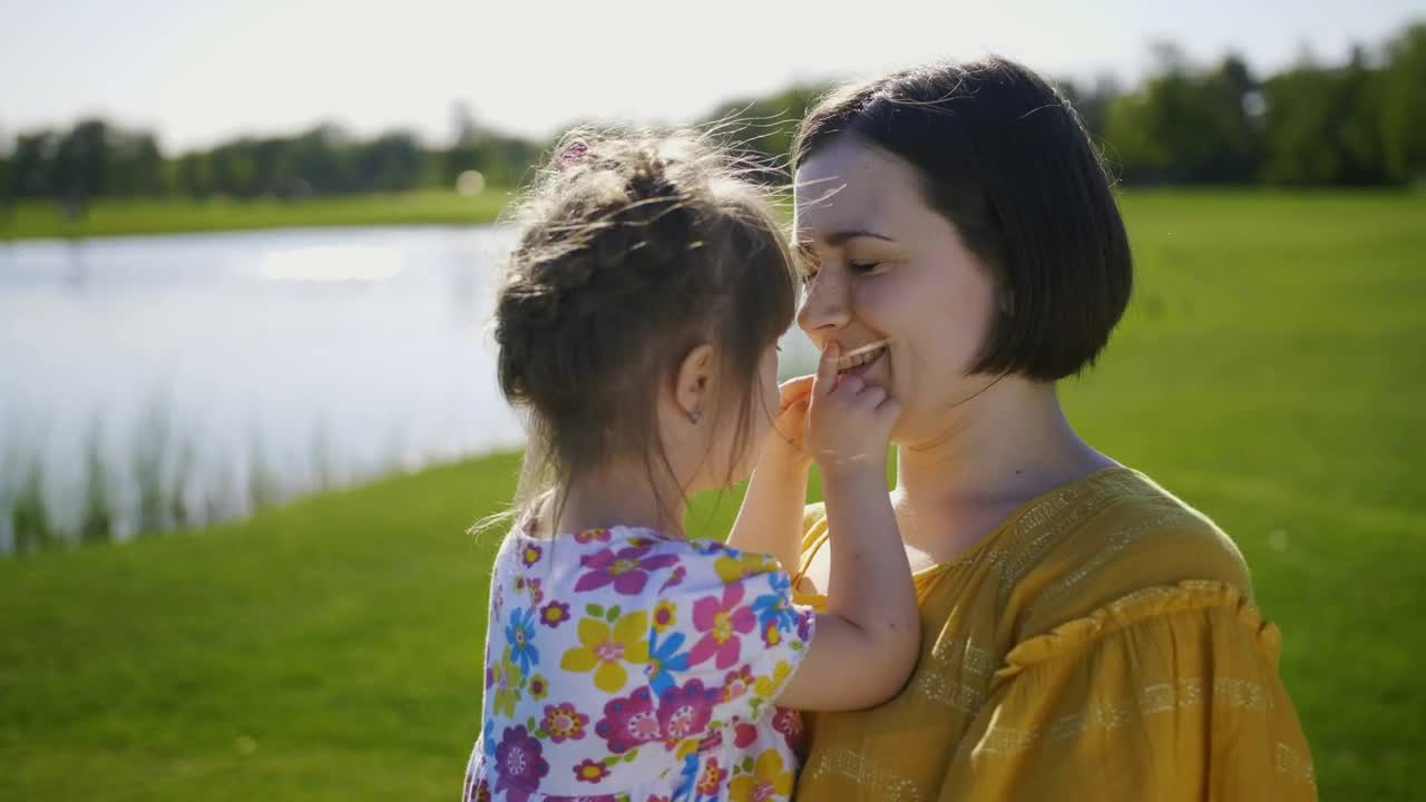 Download Stock Video Mother Kissing Her Young Child In Natur Animated Wallpaper