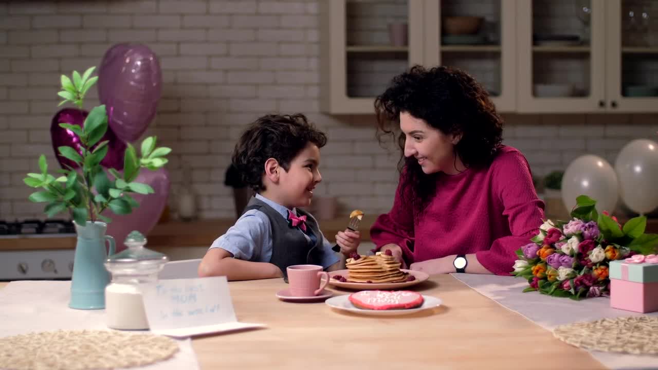 Download Stock Video Mother And Son Sharing Pancake Animated Wallpaper