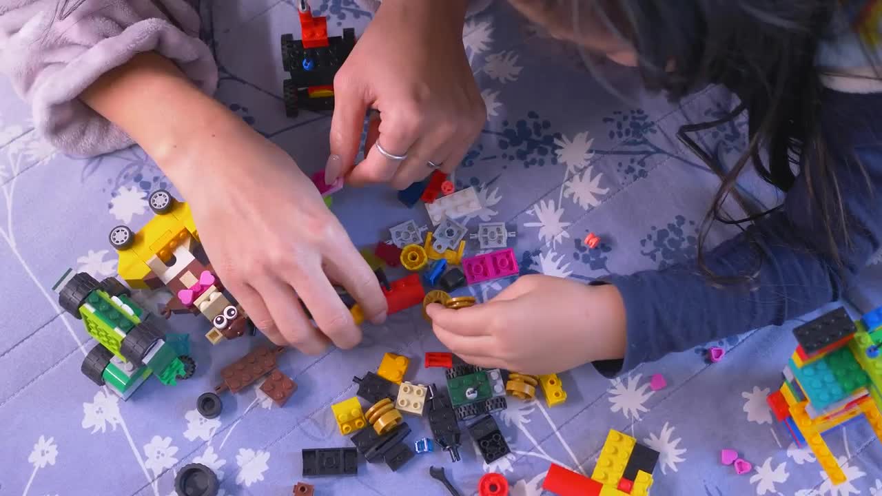 Download Stock Video Mother And Her Daughter Playing With Lego Piece Animated Wallpaper