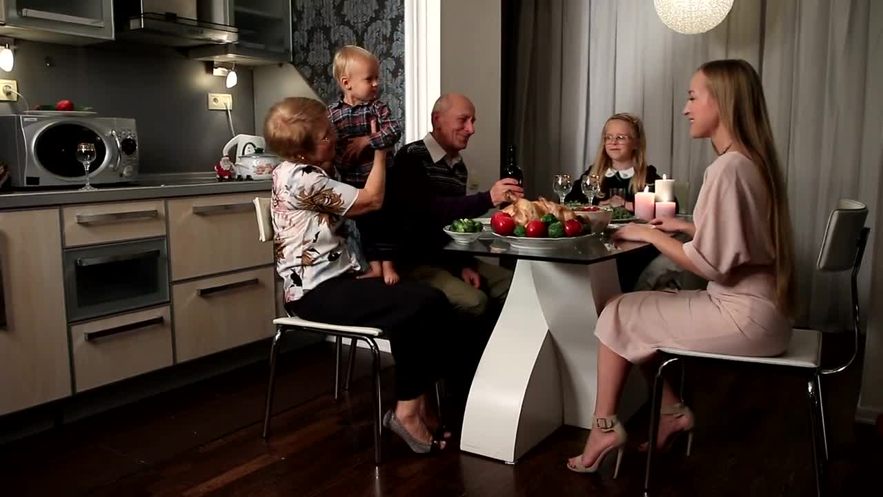 Download Stock Video Mother And Her Children At A Dinner With Grandparent Animated Wallpaper