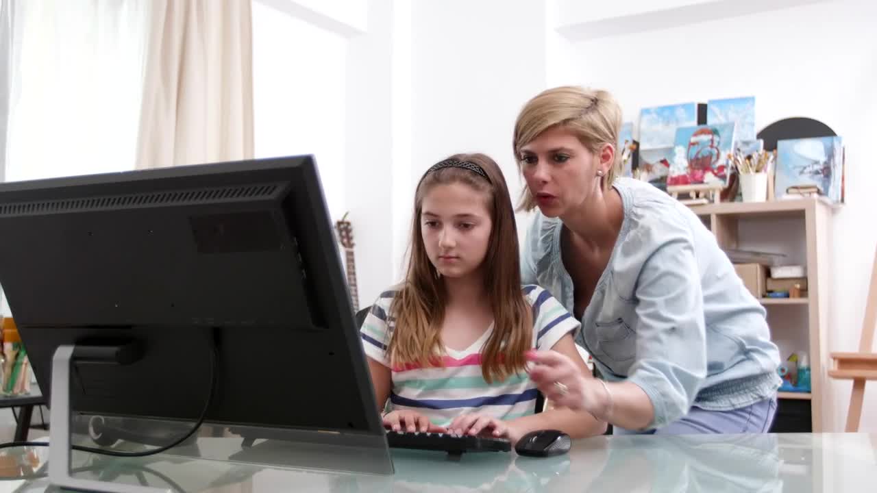 Download Stock Video Mother And Daughter Working At The Compute Animated Wallpaper