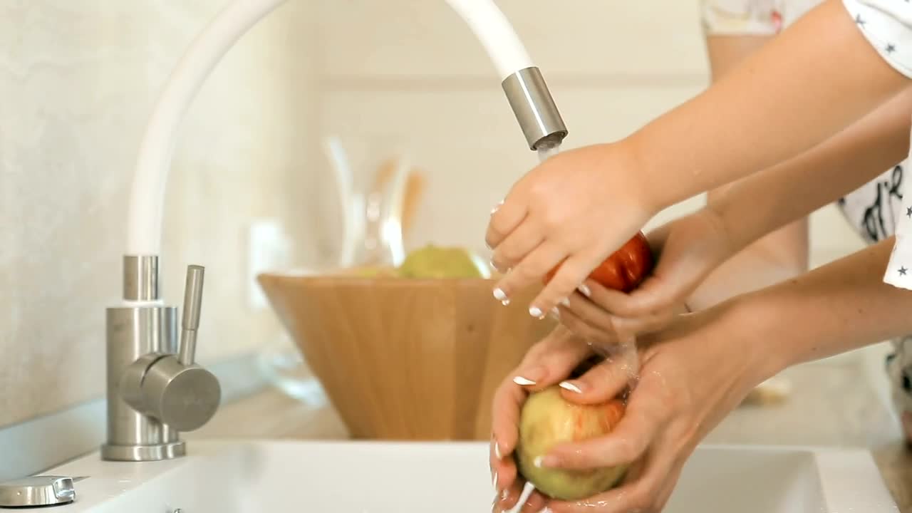 Download Stock Video Mother And Daughter Washing Apple Animated Wallpaper