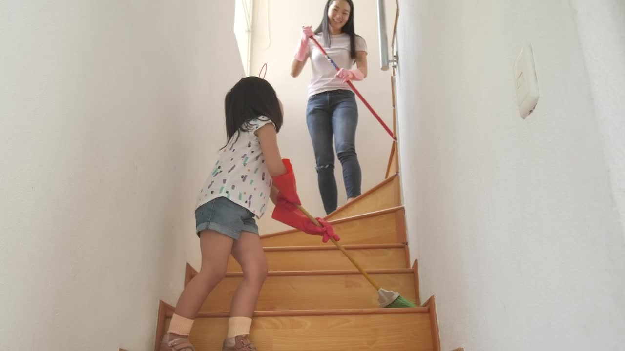 Download Stock Video Mom And Daughter Sweeping The Stairs At Hom Animated Wallpaper