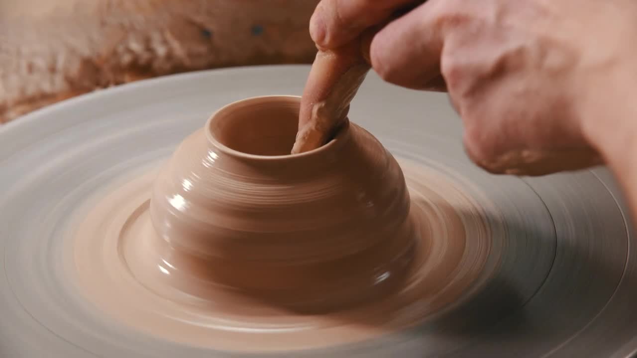 Download Stock Video Molding With Clay On The Spinning Whee Animated Wallpaper