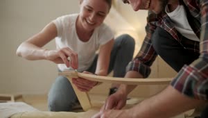 Download Stock Video Millenials Put Together Furniture In New Apartmen Animated Wallpaper