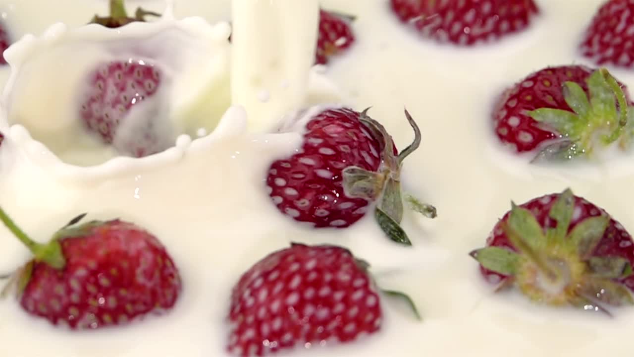 Download Stock Video Milk Poured On Strawberrie Animated Wallpaper