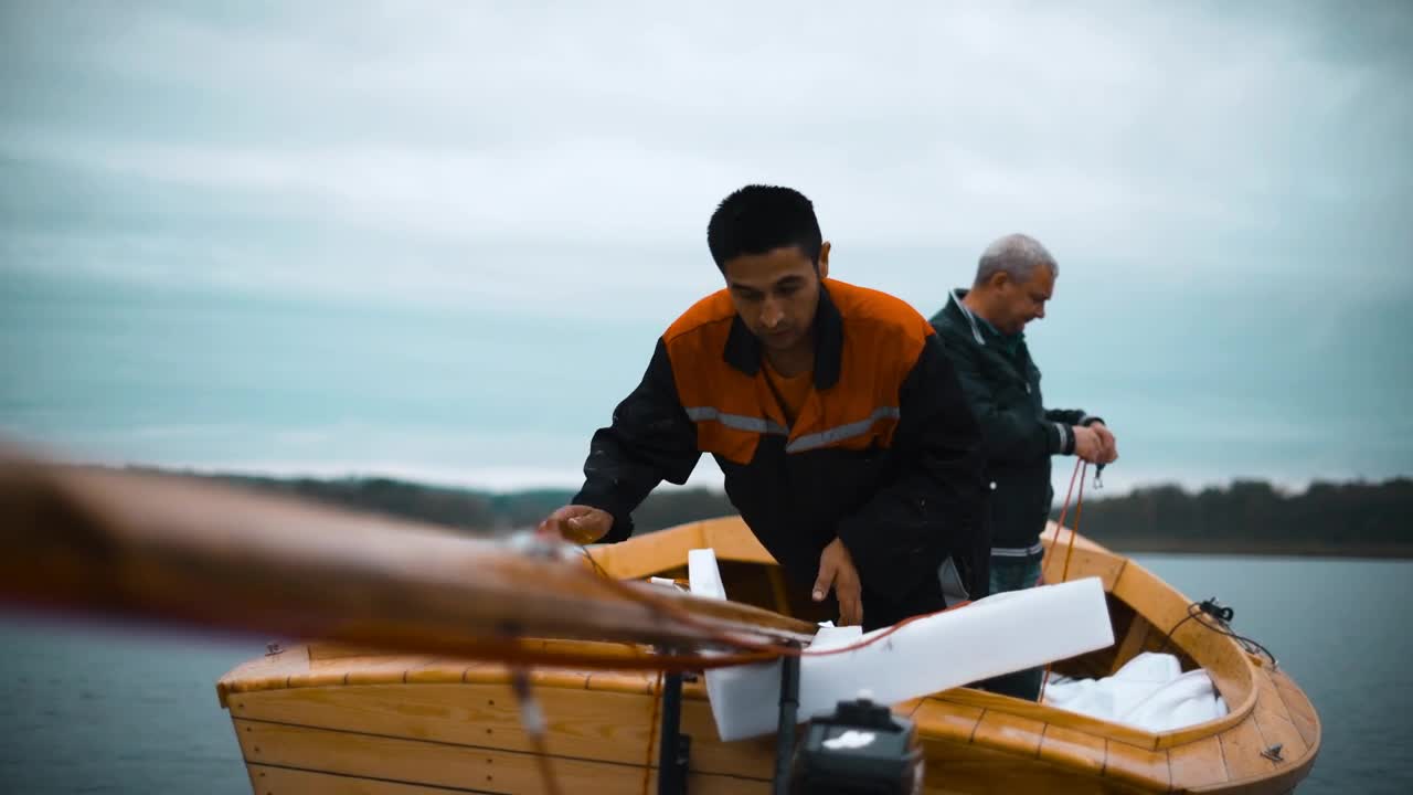 Download Stock Video Men Placing The Mast Of A Sailboa Animated Wallpaper