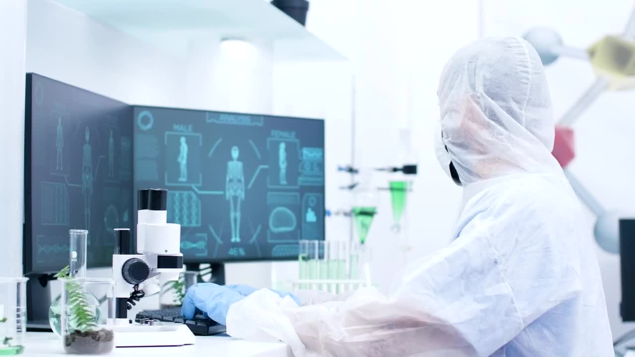 Download Stock Video Medical Scientist Types And Looks At Human Body Sca Animated Wallpaper