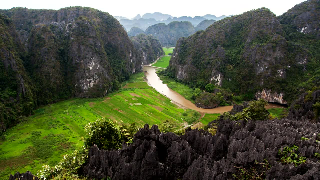 Download Stock Video Meadow Surrounded By Mountains With A Strea Animated Wallpaper