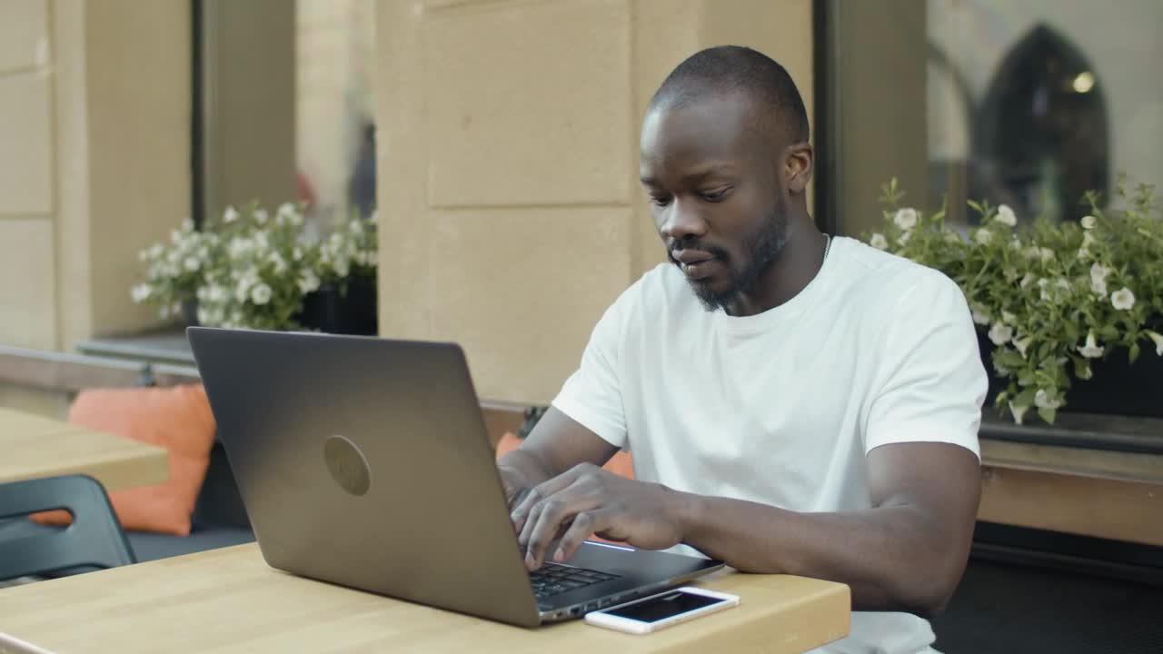 Download Stock Video Man Working Remotely From A Coffee Sho Animated Wallpaper