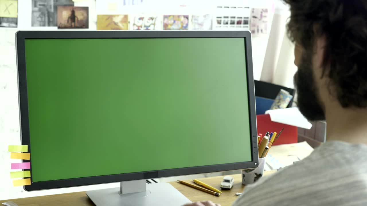 Download Stock Video Man Working On A Computer With A Green Scree Animated Wallpaper