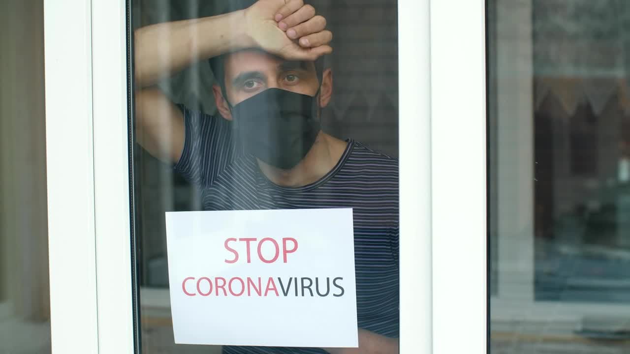 Download Stock Video Man With Coronavirus Sign In The Windo Animated Wallpaper