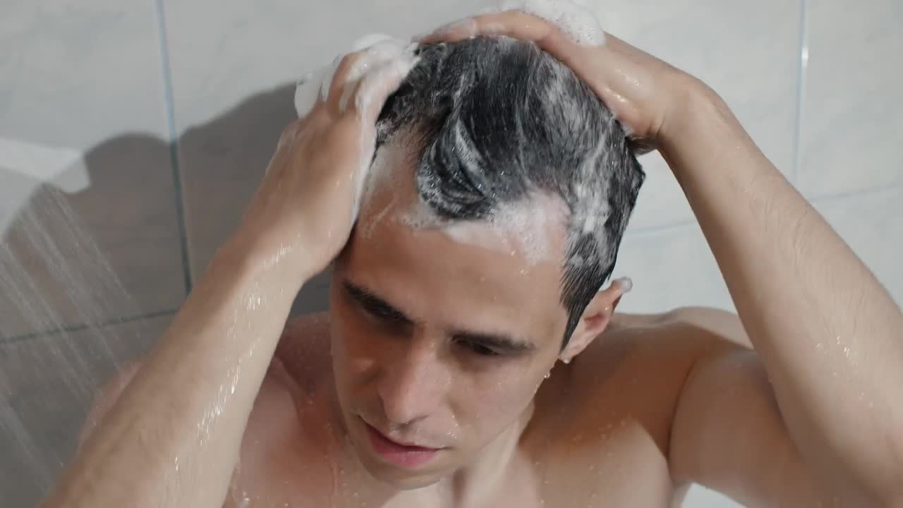 Download Stock Video Man Washing Hair In Showe Animated Wallpaper