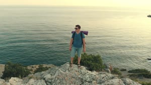 Download Stock Video Man Standing On A Cliff Facing The Se Animated Wallpaper