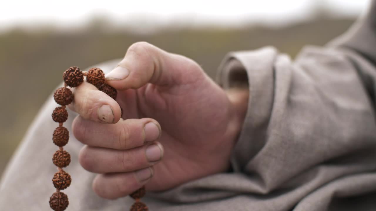 Download Stock Video Man Praying With A Rosary Close Up Of Hand Animated Wallpaper