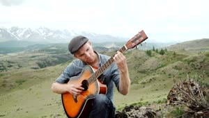 Download Stock Video Man Plays Acoustic Guitar On Ridge Above Mountain Landscap Animated Wallpaper