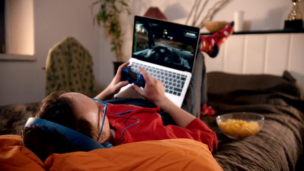 Download Stock Video Man Playing Video Games Lying In His Roo Animated Wallpaper