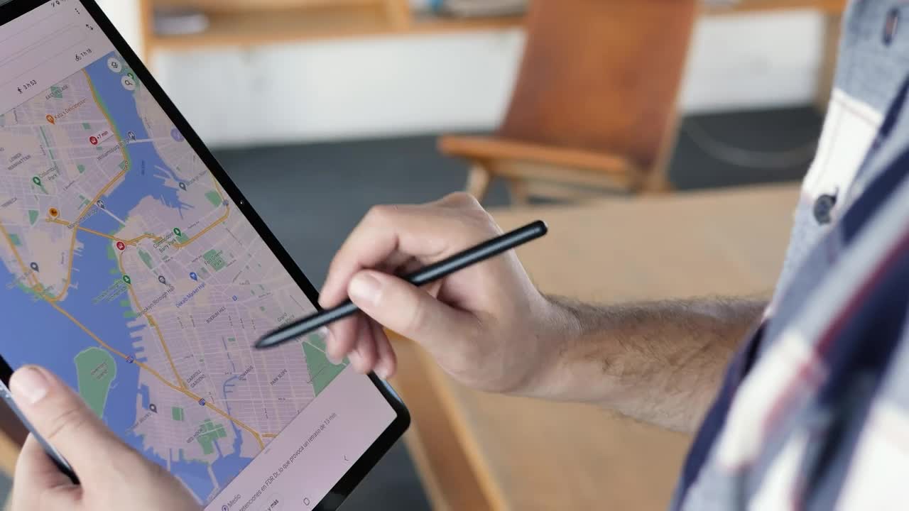 Download Stock Video Man Locating An Area On A Map On A Table Animated Wallpaper